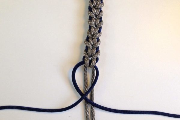 Once you have made your bracelet the length you want, cross the blue strands around the grey one more time.