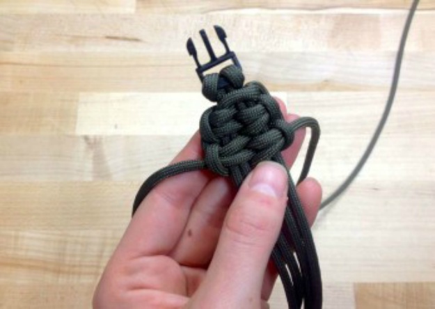 Pull the left strand over the right strand | How To Make A Paracord Bracelet: Blaze Bar Quick Deploy | how to make a paracord bracelet | easy paracord bracelet instructions