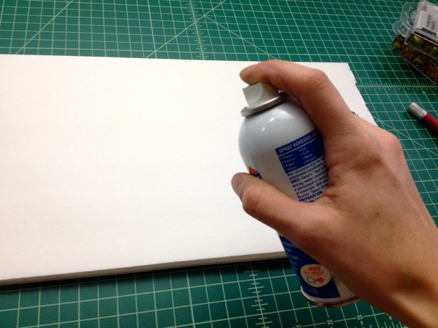 Using the spray adhesive, stick your word template onto the foam core.