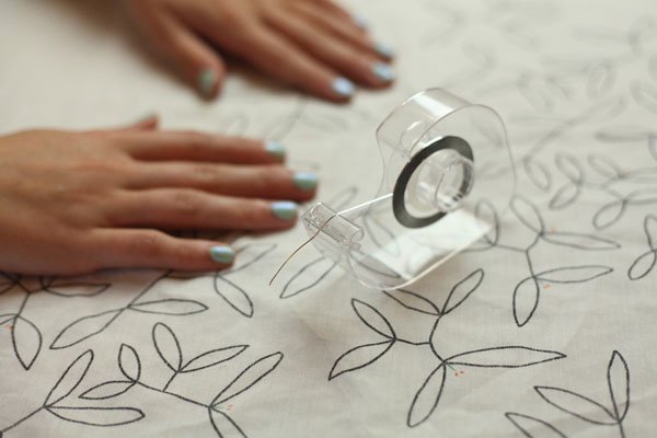 Re-use an old tape dispenser to hold nail tape.