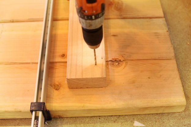 Drill pilot holes for your wood screws into the support beam | DIY Pipe Leg Table | Workbench Plans And Rustic Furniture Tutorial