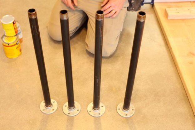Grab four pipes and screw a floor flange into one side | DIY Pipe Leg Table | Workbench Plans And Rustic Furniture Tutorial