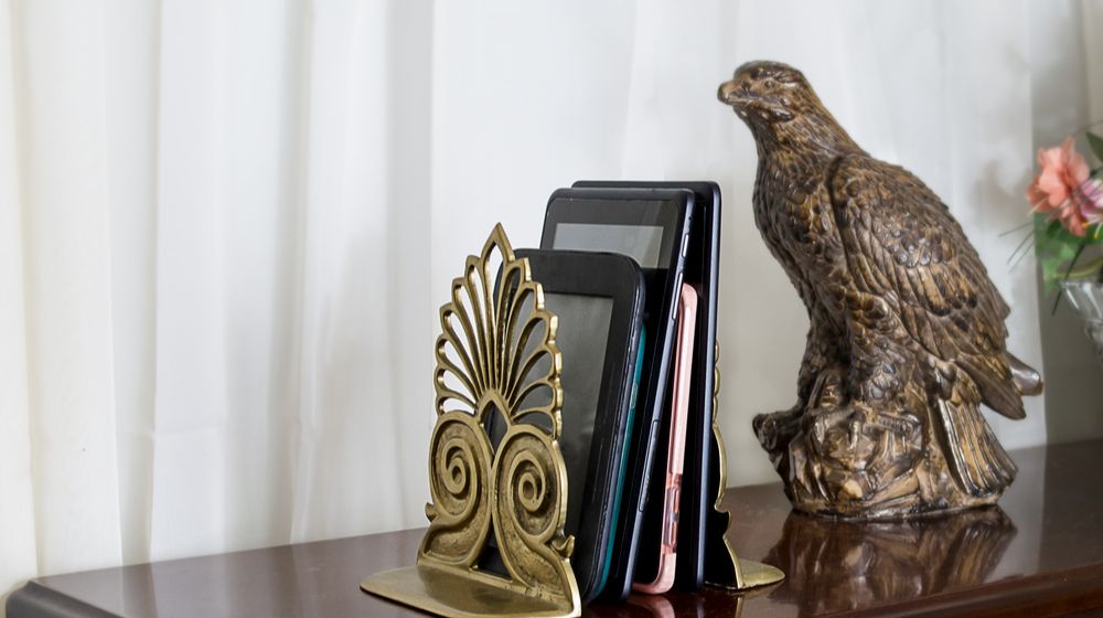 Depiction of a modern home library with e books between bookends on a table | DIY Father's Day Gift Ideas Faux Copper Eagle Bookends | Featured
