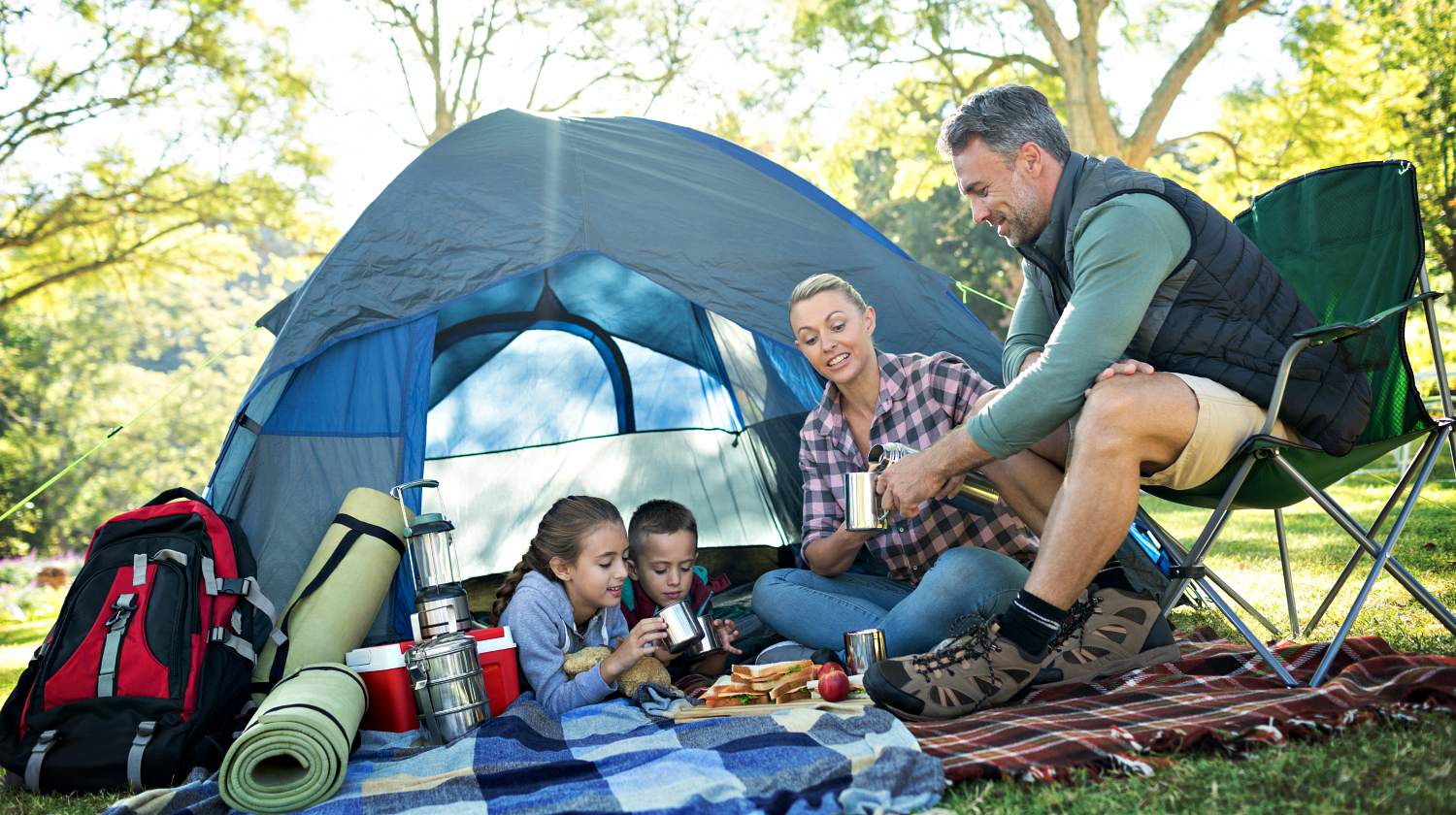 Feature | Family having snacks and coffee outside the tent at campsite | Camping Snacks Recipes