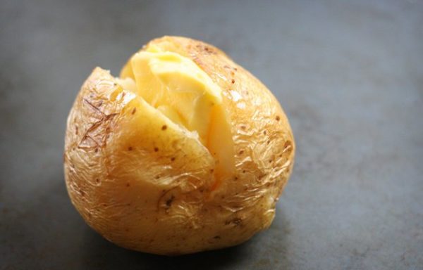 Split the baked potato in the middle and drop a chunk of butter.