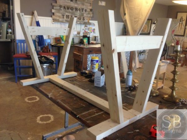 Attach the legs of your DIY outdoor to the frame. 