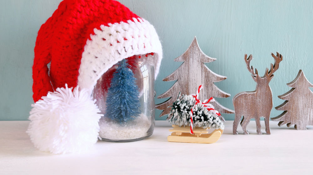 Image of cute knitted santa hat on mason jar with christmas tree | DIY Snow Globe Soap | diy snow globe soap | Featured