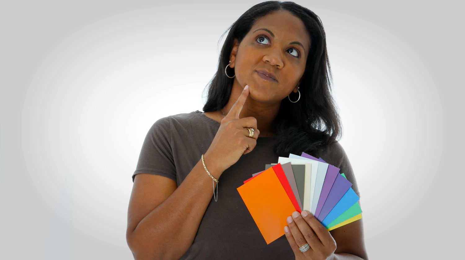 Woman thinking and looking at paint chips to use | Fun & Creative DIY Paint Chip Calendar