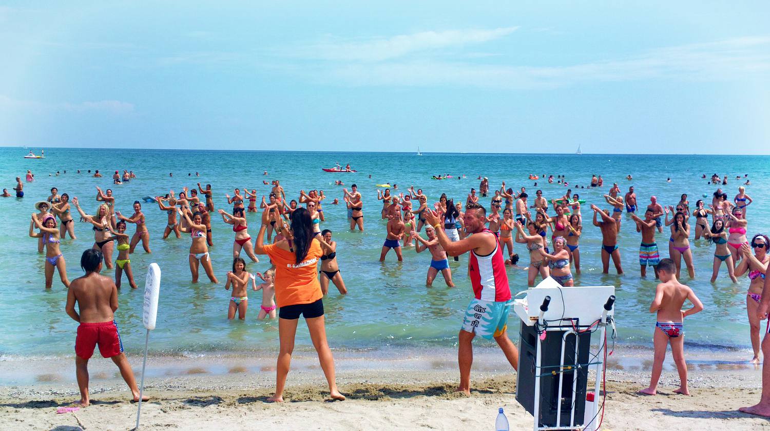 Feature | A group of people dancing at the beach | Fun Summer Activities You Can DIY!