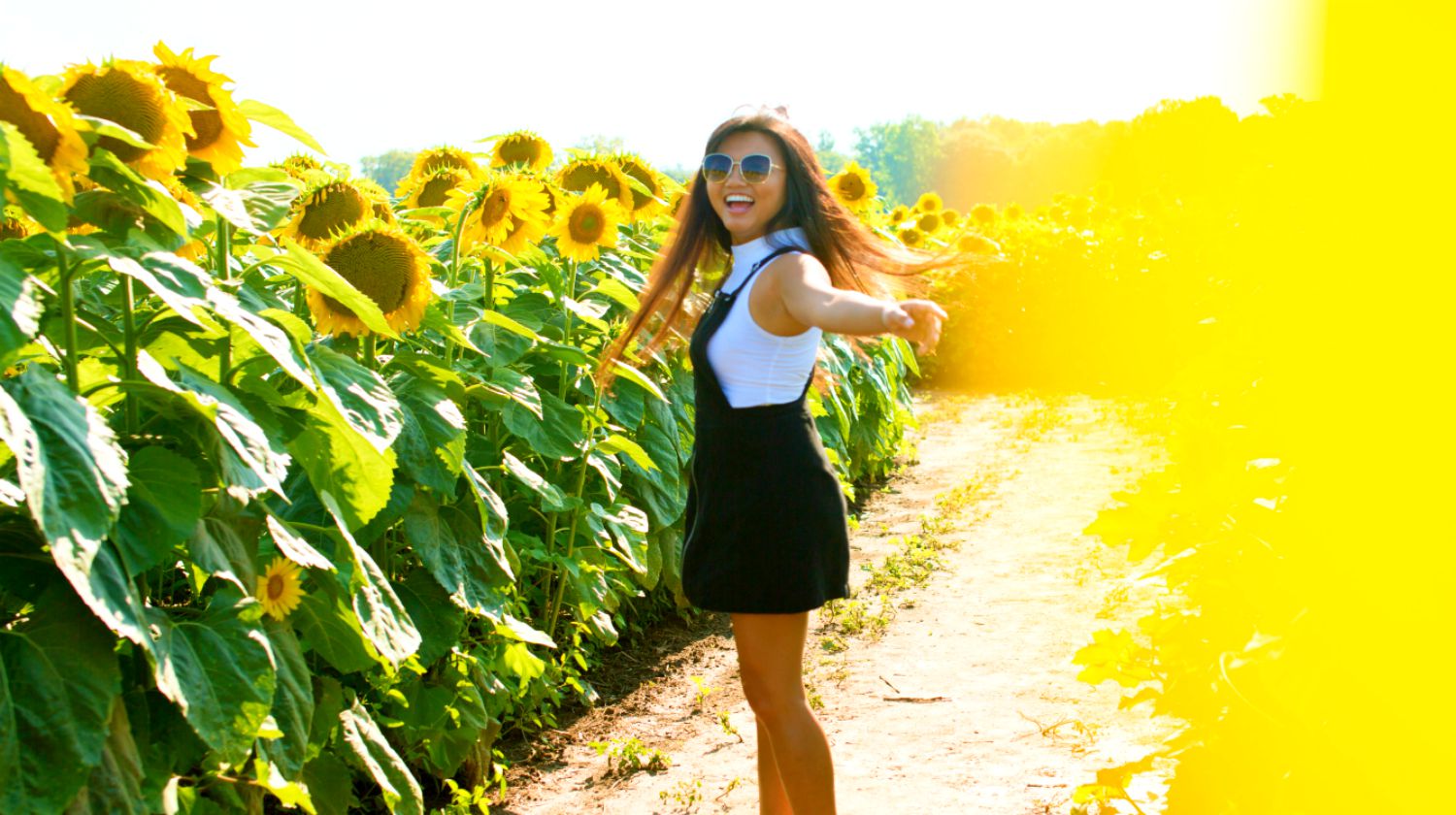 Feature | A woman in sunflower field happy smiling | DIY Overalls On The Cheap | Fashion Projects