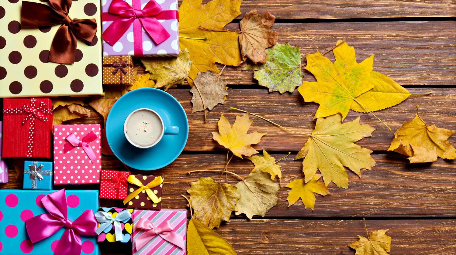 Cup of coffee and season gifts with leaves on wooden background | Awesome Fall Leaf Activities | Featured
