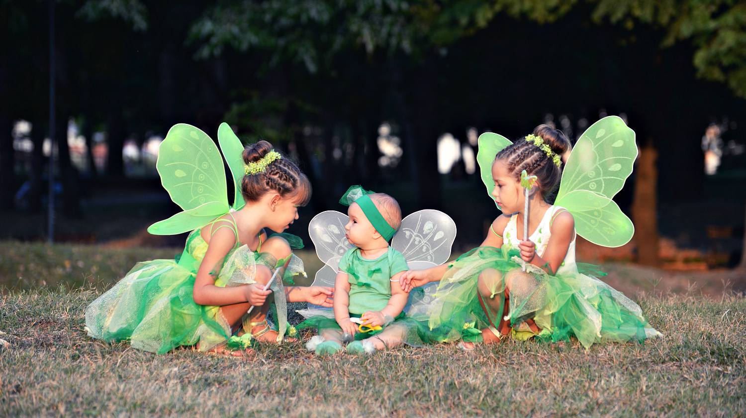 Baby and two girls in green fairy costumes with wings in the park | DIY Tinkerbell Costume Ideas | Featured