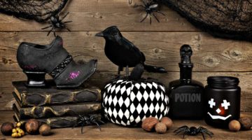 Spooky black Halloween decor against an old rustic wood background | Creepy Halloween Decor Ideas To Increase Your BOO Factor | Featured