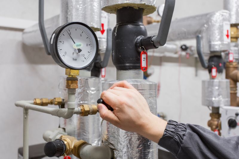 technician-checking-water-pressure | furnace maintenance schedule