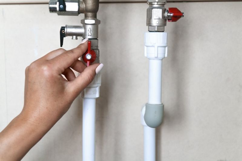 womans-hand-opens-closes-red-water | heater tune-up specials