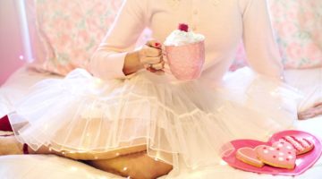 Feature | Woman holding hot chocalate beside heart shape cookies | Delectable Valentine's Day Treats You Can Make