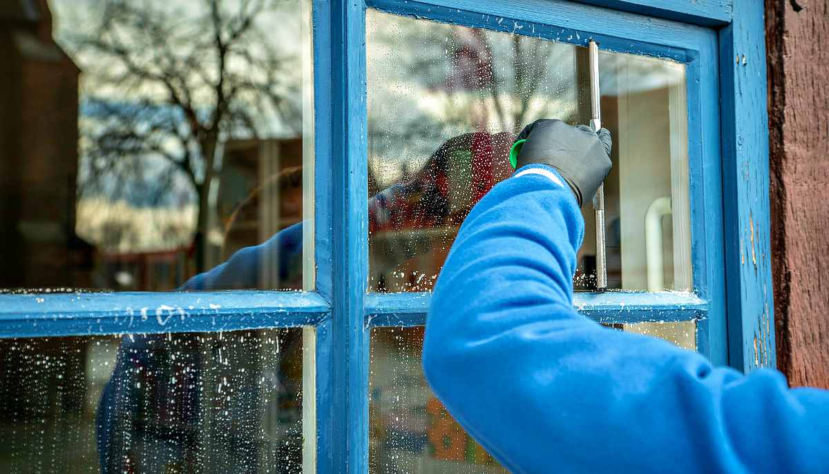 A man cleaning window | DIY Spring Cleaning Tips And Tricks