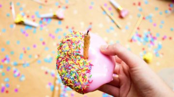 Feature | donut with a candle and sprinkles | Best Kids Party Ideas | unique birthday party places