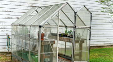 A farmer's green house on a spring day | How To Build A DIY Greenhouse | Greenhouse Design Ideas | how to build a greenhouse cheap | Featured