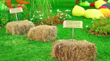 Amazing chairs made from straw hay stack and backrest from pitchfork on the summer lawn at the backyard garden | Featured