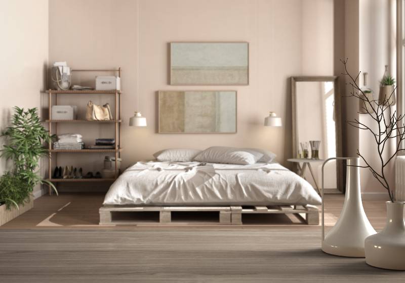 Wooden table top or shelf with minimalistic modern vases over blurred country rustic bedroom with diy pallet bed | DIY Platform Beds To Update Your Bed Frame