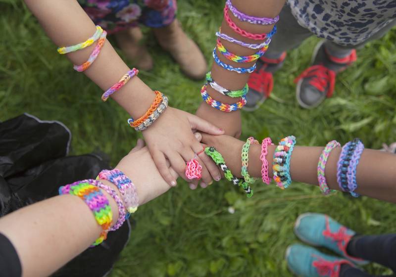 Girls with loom bracelets putting their hands together | Friendship Bracelets