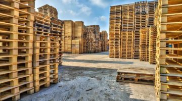 Piles of euro type cargo pallets at a recycling business area | Pallet 101: Types, Standard Pallet Size And More | Featured