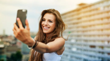 Happy young woman taking selfie on rootfop | Instagram Hacks Everyone Should Know | instagram hacks that work | Featured