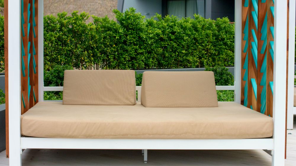Garden bed with pillows near swimming pool | DIY Outdoor Daybed Project You Can Do While You're Stuck At Home | Featured