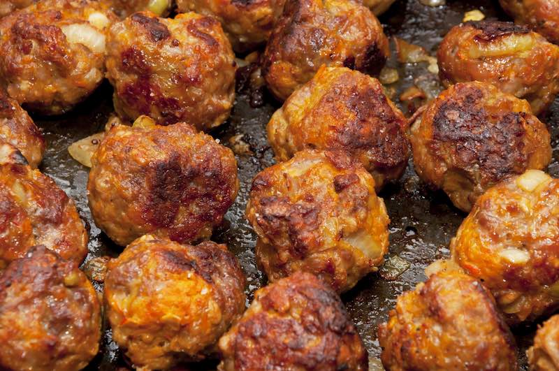 Delicious rustic famous roasted meat balls with carrot and onion on the tray just from oven | dog treat