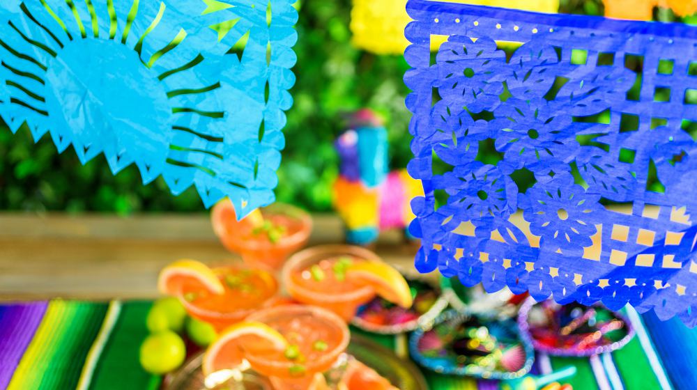 Picado banner over the table at the garden party | DIY Cinco de Mayo Decorations And Crafts For Your Home Fiesta | cinco de mayo crafts | Featured