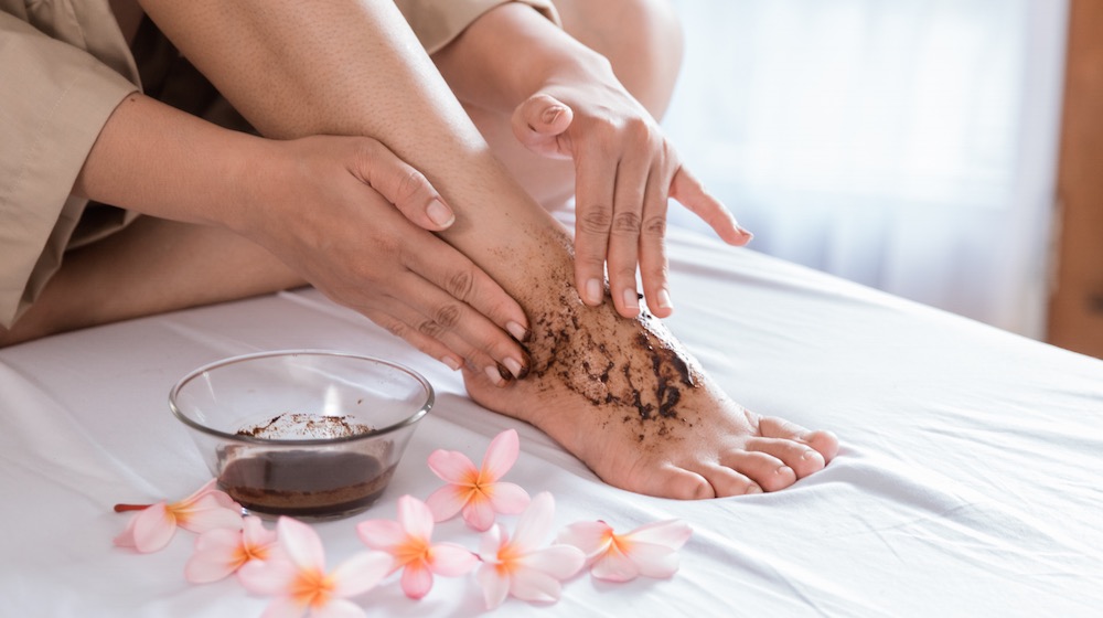 person applying foot scrub | DIY Foot Scrub Recipe For Your Own Home Spa | featured