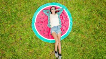 girl lying down on towel | DIY Round Beach Towel Or Blanket For Your Next Beach Getaway | featured