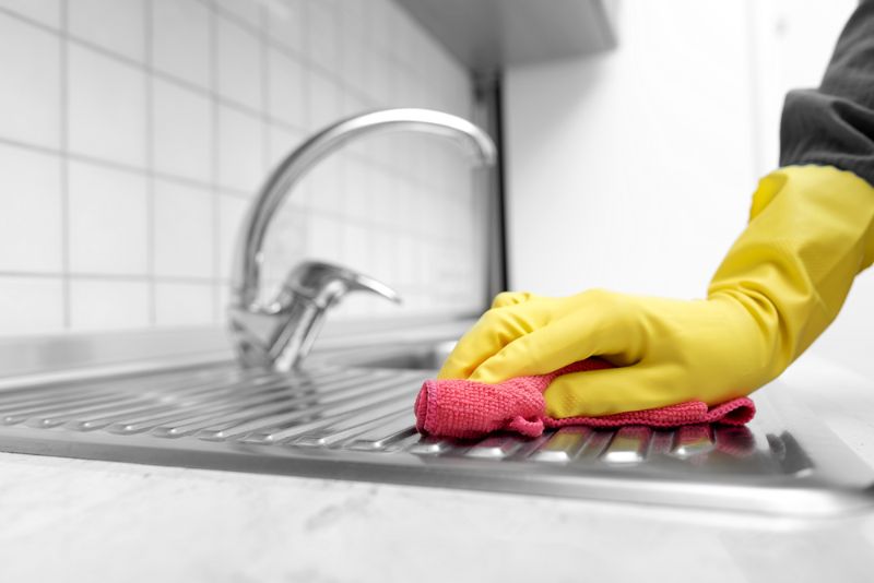 hands-yellow-gloves-washing-kitchen-sink | diy natural cleaning products