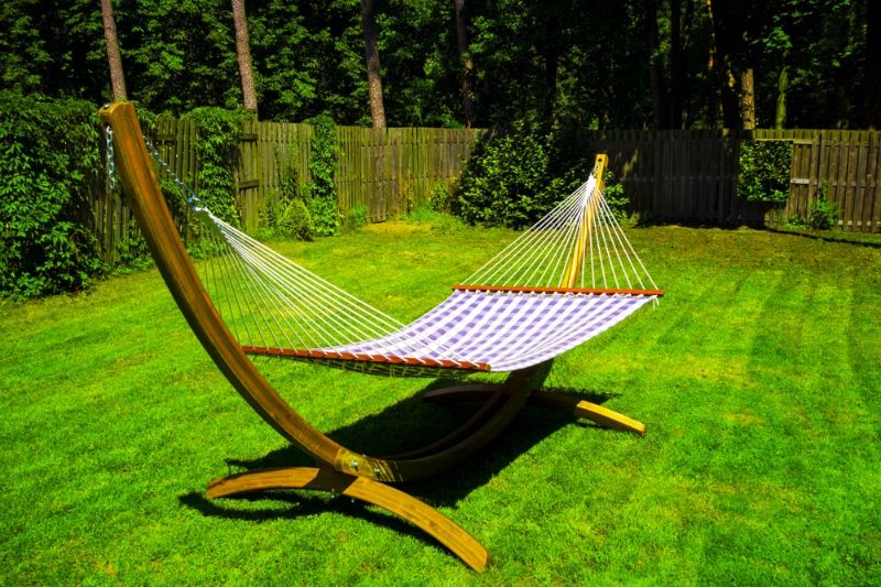 sunny-wooden-hammock-standing-green-garden | backyard ideas