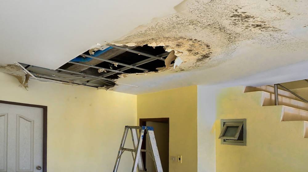 water-leak-leaks-down-rooftop-floor | A Beginner's Guide To Ceiling Repair | Featured