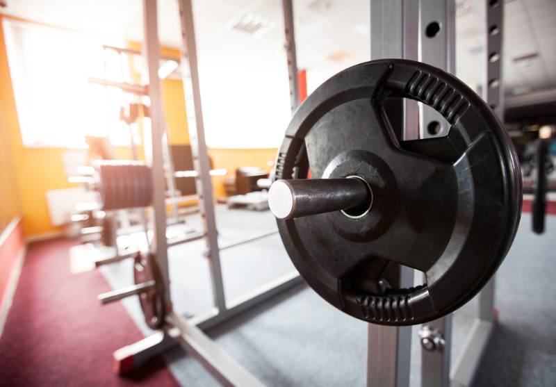 dumb bells lined gym | squat rack dimensions