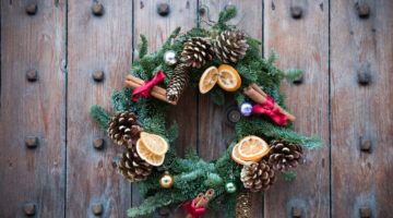 christmas-wreath-on-wood-door | DIY Pine Cone Flower Wreath To Dress Up Your Doors For Fall | Featured