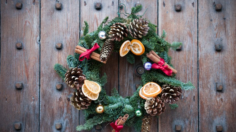 christmas-wreath-on-wood-door | DIY Pine Cone Flower Wreath To Dress Up Your Doors For Fall | Featured