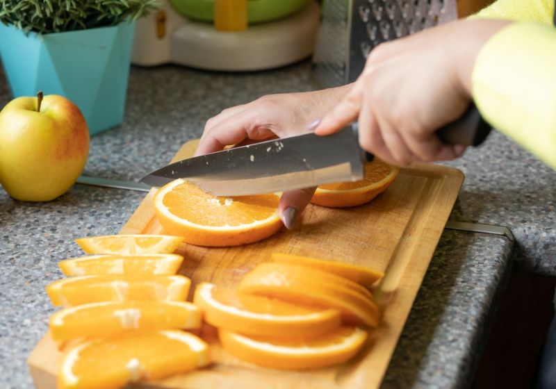 close-view-female-hands-slicing-oranges | christmas potpourri