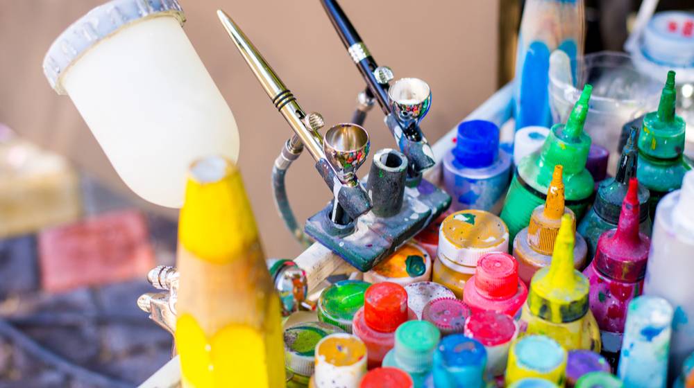 professional-airbrush-on-stand-colorful-paints | Interesting Ways To Use Your Airbrush Kit For DIY Projects | Featured
