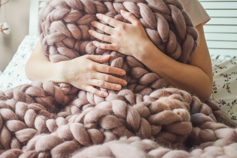 girl-wrapped-big-merino-wool-blanket | gifts for grandma cheap