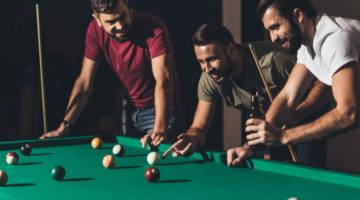 group-young-handsome-men-playing-pool | DIY Pool Table You Can Make For Your Man Cave | Featured