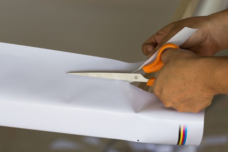 women-hand-cutting-vinyl-fabric-scissors | custom laptop skin