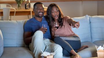 black-african-couple-watching-movie-television | DIY Valentine Movie Night Ideas | Featured