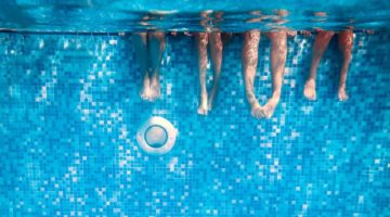 childrens-adults-legs-underwater-swimming-pool | DIY Pool Heater Without Breaking The Bank | Featured