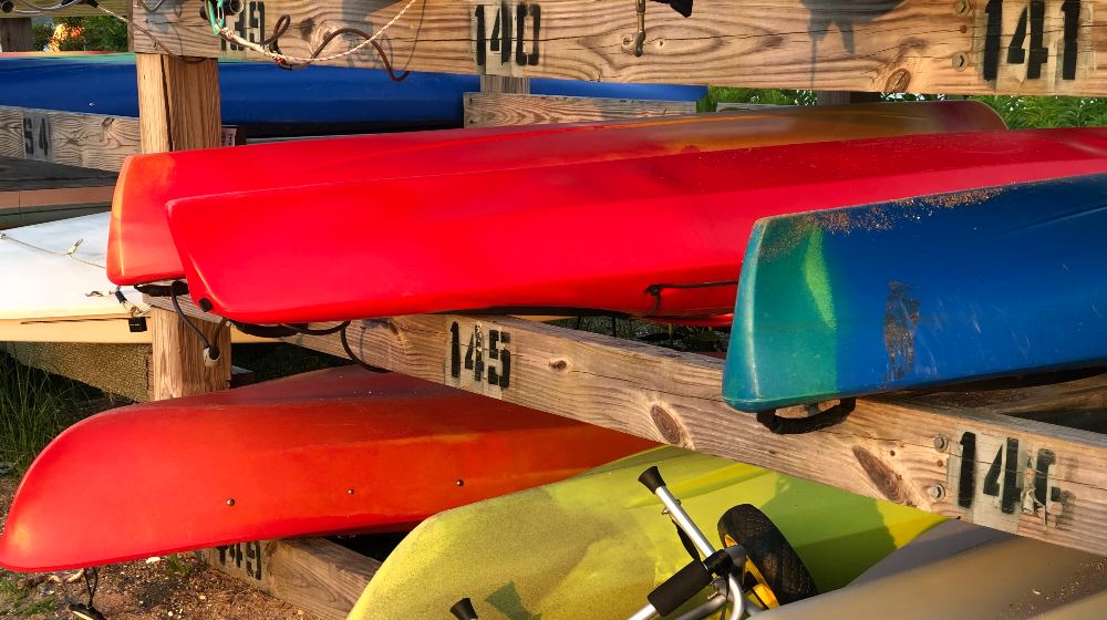 Colorful Kayaks Stored on Rack at Beach | DIY Kayak Racks | Featured