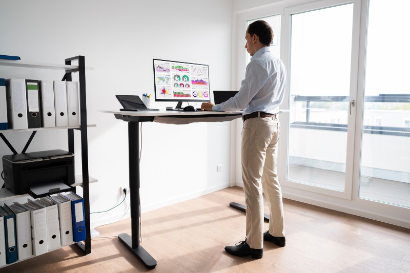 Man Working on Computer Standing Desk | DIY Corner Desk
