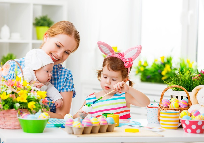 Easter Crafts for Toddlers _ happy family mother and two children in costumes rabbit preparing for Easter, paint eggs and decorate the home