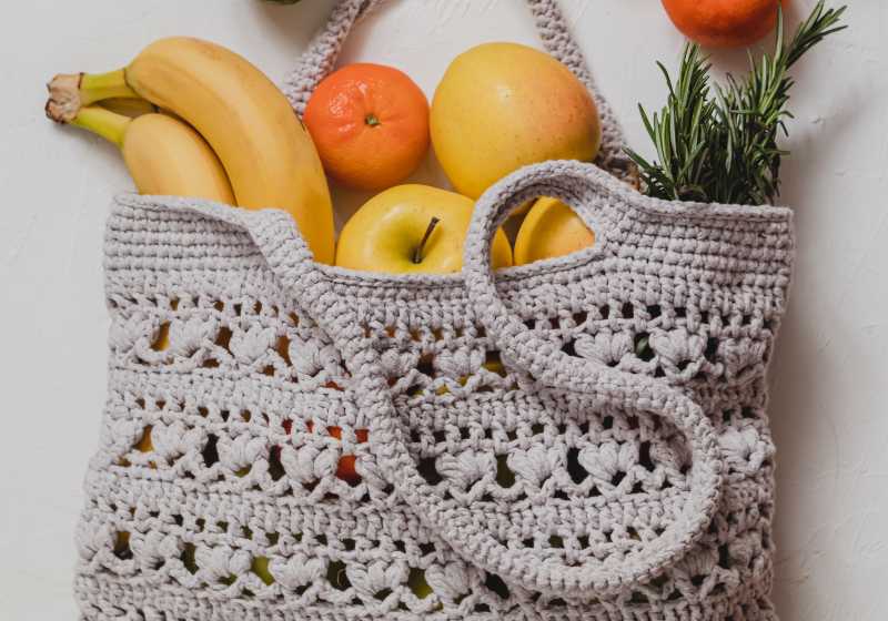 Crochet eco bag with fresh fruits on a white background | Easy Knit Produce Bag